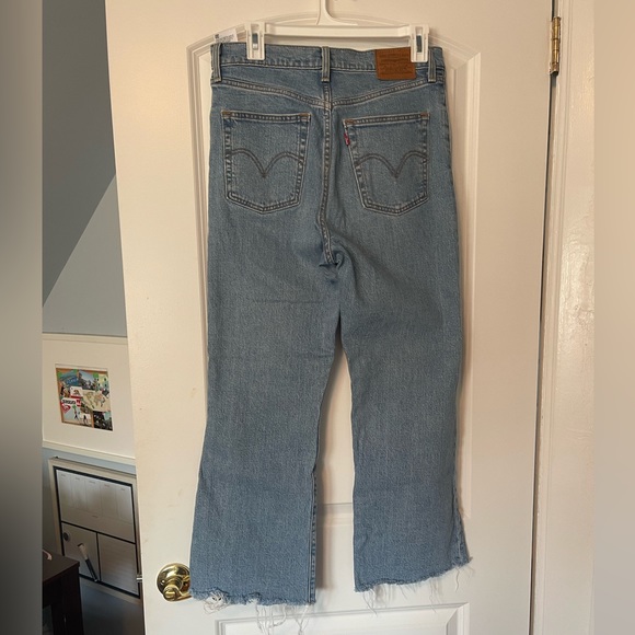 Ribcage Crop Flare jeans with button closure and frayed hem. - Picture 1 of 4